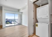 Thumbnail 19 of 75 - a washer and dryer in a room with a balcony