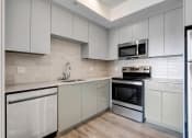 Thumbnail 16 of 75 - a kitchen with white cabinets and stainless steel appliances