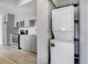 Thumbnail 50 of 75 - a white washer and dryer in a white kitchen