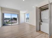 Thumbnail 33 of 75 - a bedroom apartment in the building with a washer and dryer