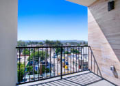 Thumbnail 35 of 75 - a balcony with a view of a parking lot