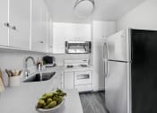 Thumbnail 14 of 52 - a white kitchen with a sink and a refrigerator
