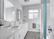 Thumbnail 19 of 52 - a bathroom with two sinks and a mirror