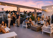 Thumbnail 20 of 20 - A group of people are gathered on a rooftop terrace.
