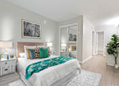 Thumbnail 27 of 76 - Bedroom with mirrored closet doors and a vanity area with wood-inspired floors throughout