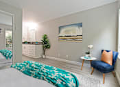 Thumbnail 26 of 76 - Bedroom with wood-inspired floors, mirrored closet doors and a vanity area on the left