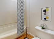 Thumbnail 11 of 29 - a bathroom with a shower and a sink and a toilet