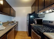 Thumbnail 1 of 29 - a kitchen with a stove and a sink and a refrigerator