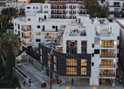 Thumbnail 16 of 119 - A modern building with black and white exterior is seen from an aerial perspective.