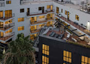 Thumbnail 11 of 119 - A modern building with balconies and a staircase.