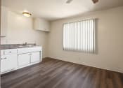 Thumbnail 14 of 48 - Dining area with ceiling fan, kitchen at the left, wood flooring throughout