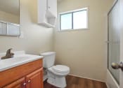 Thumbnail 17 of 48 - Bathroom with shower and tub combo at the right, single vanity with wood style cabinet
