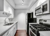 Thumbnail 8 of 39 - a kitchen with white cabinets and stainless steel appliances