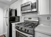 Thumbnail 7 of 39 - a kitchen with a stove top oven next to a refrigerator