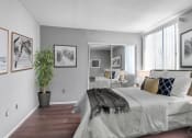 Thumbnail 13 of 39 - a bedroom with a large bed and a large mirror