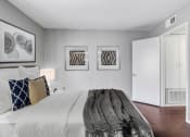Thumbnail 14 of 39 - a bedroom with a bed and two paintings on the wall