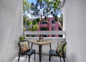 Thumbnail 16 of 39 - a balcony with two chairs and a table
