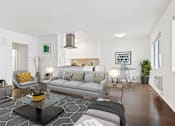 Thumbnail 14 of 31 - a living room with white walls and hardwood floors