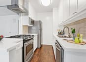 Thumbnail 13 of 31 - a kitchen with white cabinets and stainless steel appliances