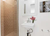 Thumbnail 18 of 31 - a bathroom with a sink and a mirror