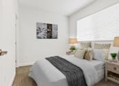 Thumbnail 8 of 32 - a bedroom with a bed and two night stands with lamps