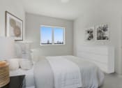 Thumbnail 18 of 26 - a bedroom with a bed and two windows