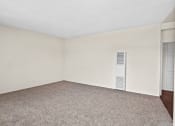 Thumbnail 10 of 48 - a bedroom with white walls and a carpeted floor