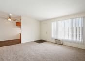 Thumbnail 9 of 48 - a bedroom with a large window and a ceiling fan