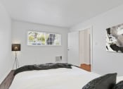 Thumbnail 15 of 61 - a bedroom with a large bed and a lamp on the side of the bed