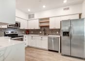 Thumbnail 2 of 50 - Fully-equipped kitchen with side by side refrigerator