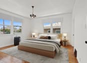 Thumbnail 5 of 10 - a bedroom with a bed and three windows