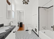 Thumbnail 8 of 10 - a bathroom with a toilet and a tub and a sink