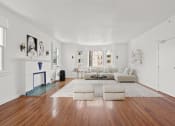 Thumbnail 2 of 10 - a living room with a white couch and a fireplace