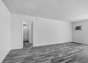 Thumbnail 28 of 66 - a bedroom with hardwood floors and white walls