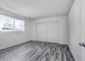 Thumbnail 26 of 66 - a bedroom with white walls and a window