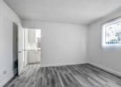 Thumbnail 25 of 66 - a bedroom with hardwood floors and white walls