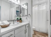 Thumbnail 29 of 66 - a bathroom with a sink and a mirror