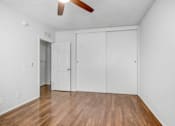 Thumbnail 31 of 31 - an empty living room with white walls and wood floors