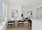 Thumbnail 31 of 163 - A modern dining room with a white table and chairs.