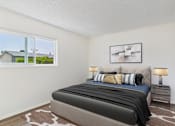 Thumbnail 54 of 81 - A bedroom with a large bed and a window overlooking a house.