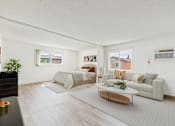 Thumbnail 46 of 81 - A living room with a grey sofa and a coffee table.