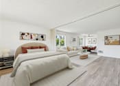 Thumbnail 48 of 81 - A bedroom with a large bed and a couch.