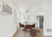 Thumbnail 47 of 81 - A dining room with a table and chairs.