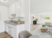 Thumbnail 45 of 81 - A kitchen with white cabinets and a marble countertop.