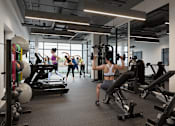 Thumbnail 3 of 15 - Gym with cardio equipment, weights, treadmills and yoga/workout area at Skylar At Sunset, Los Angeles, CA 