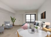 Thumbnail 25 of 38 - a living room with white walls and a white table and chairs