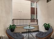 Thumbnail 27 of 38 - a balcony with two chairs and a table