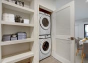 Thumbnail 30 of 38 - a washer and dryer in a laundry room