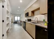 Thumbnail 2 of 38 - a kitchen and dining area in a 555 waverly unit