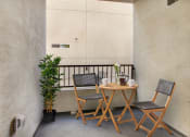 Thumbnail 24 of 38 - a small table and two chairs on a balcony